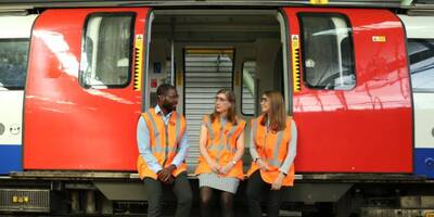 Three graduates in a tube car